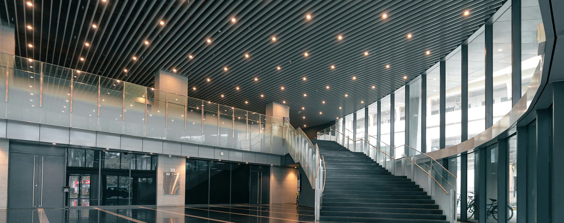 Modern commercial interior with a grand staircase and architectural lighting