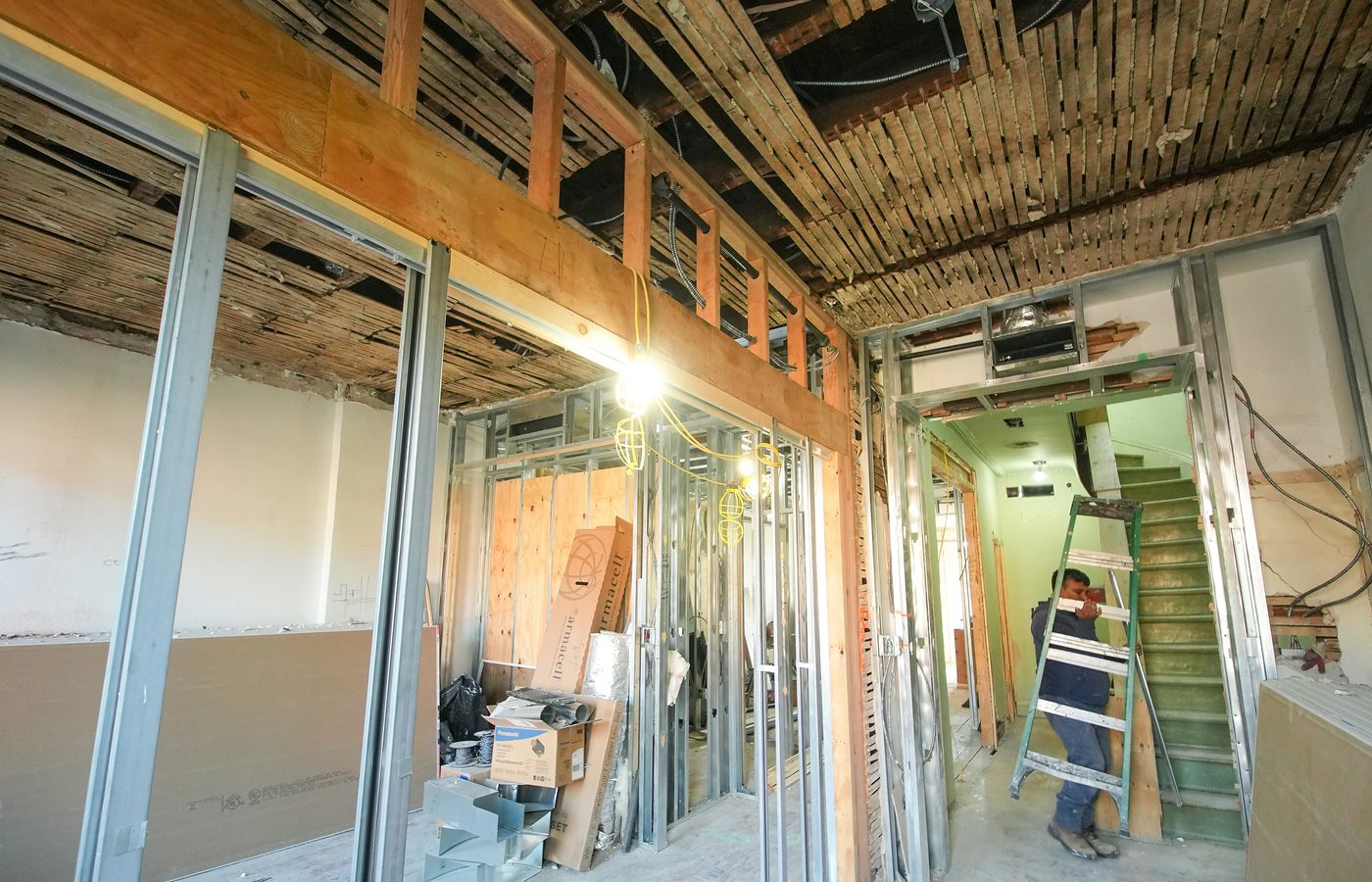 Interior renovation site with exposed framing and construction materials